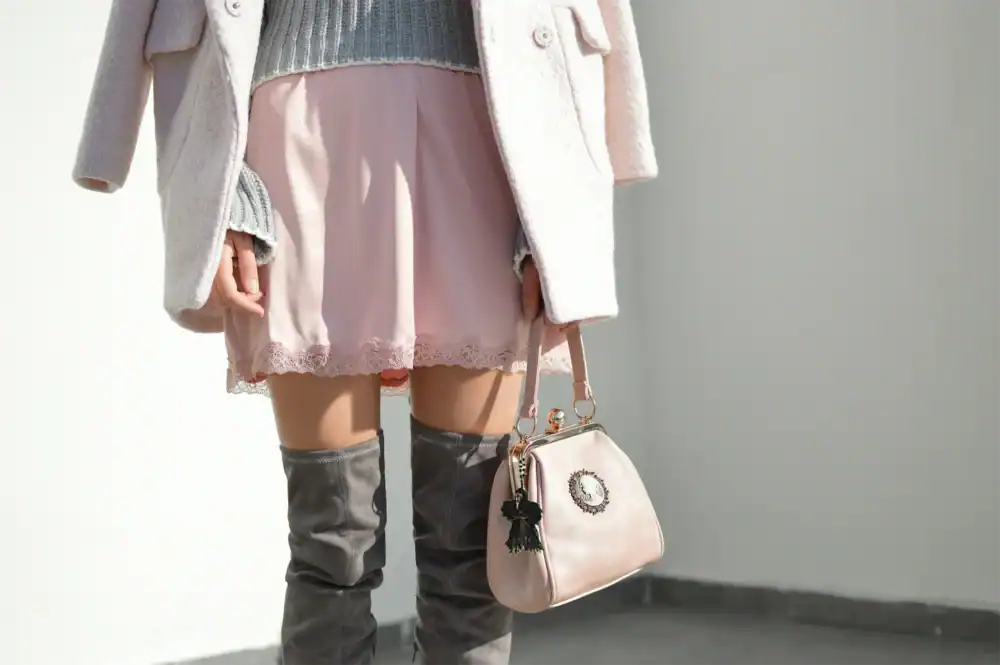 Plague Doctor Charm attached to a woman's pink purse, showing the charm's versatility.