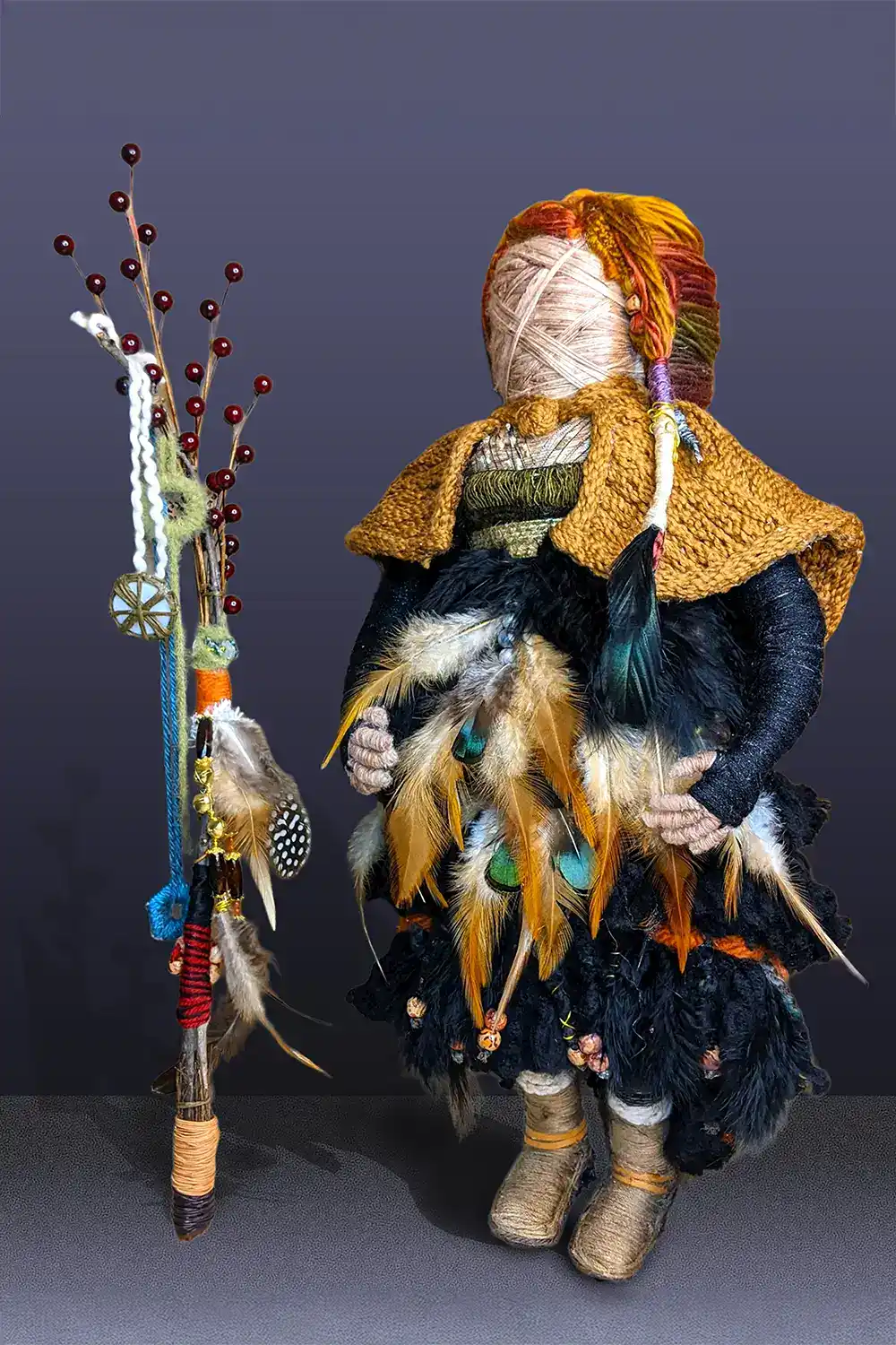 Ella the forest spirit art doll, a forest sprite adorned with feathers and standing beside her walking stick with essential oil diffusers, representing inner strength and wisdom from hidden gemstones.