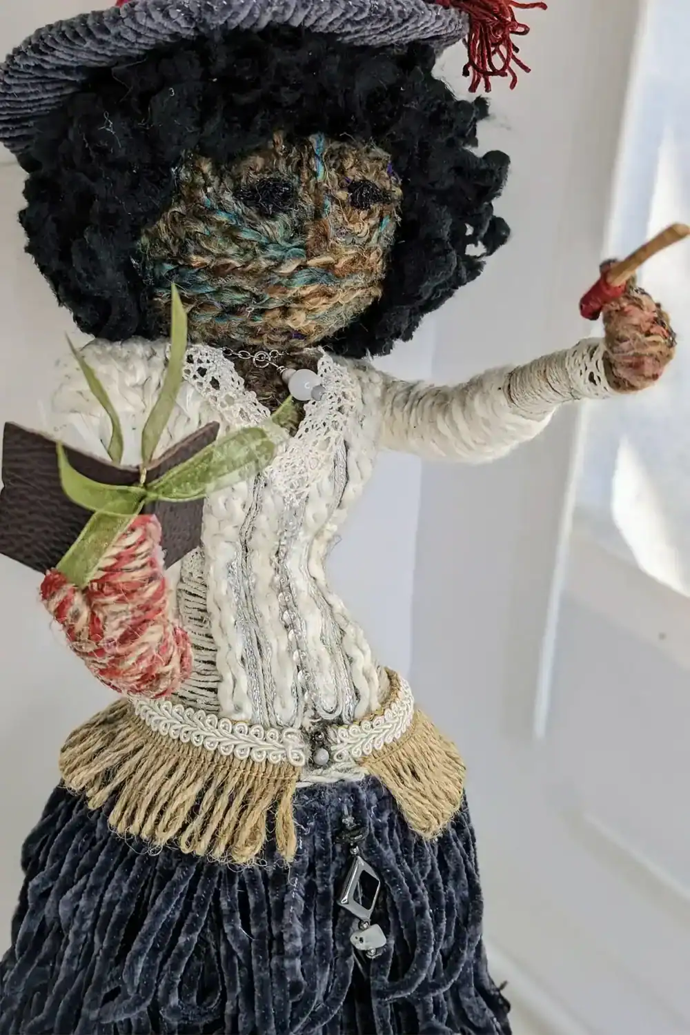 Right side view of Hannah the Kitchen Witch art doll, highlighting her textured skirt and magical accessories.