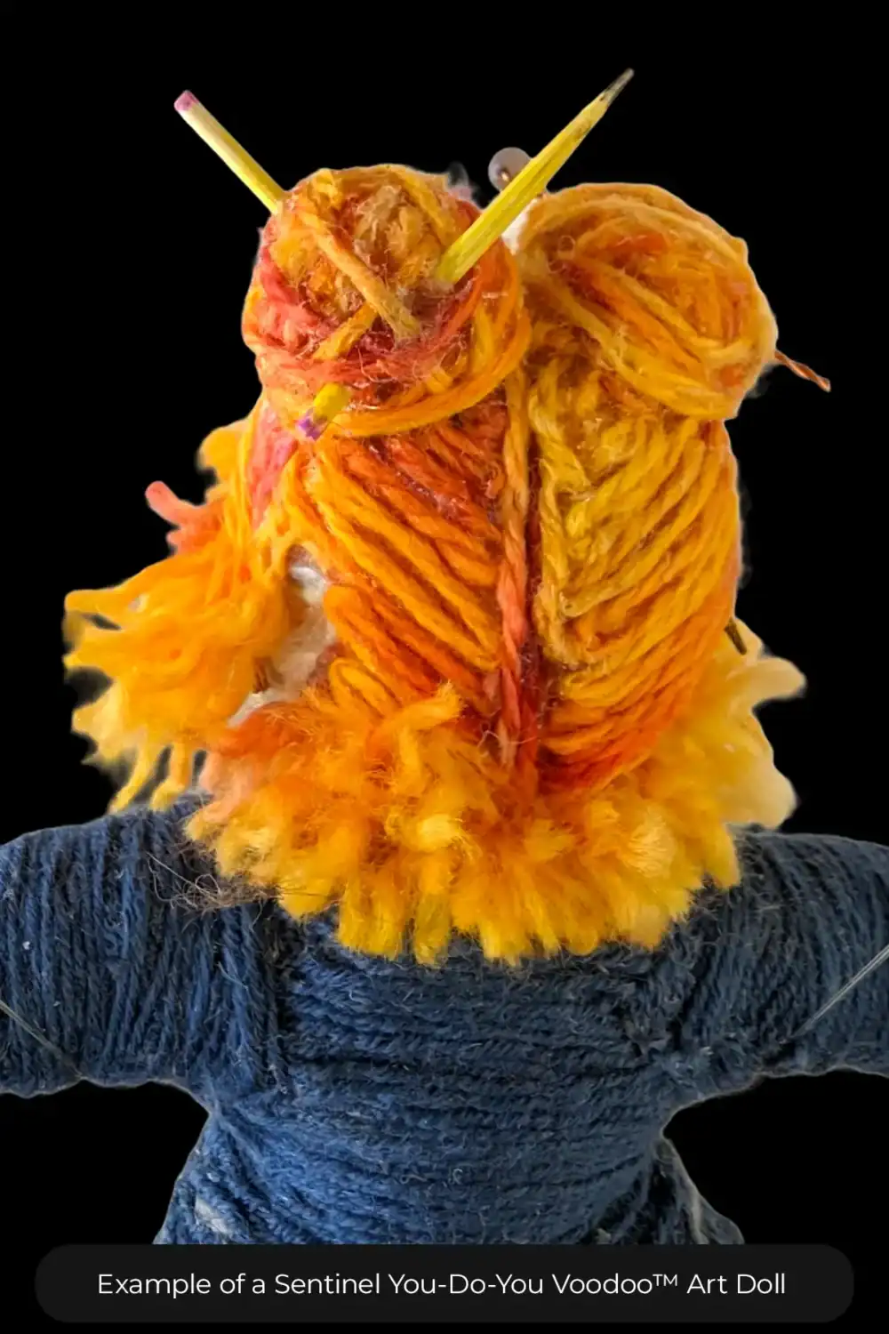 Close-up of Butterfly’s back hair detail, showcasing orange and yellow yarn styled into two buns held by pencils.