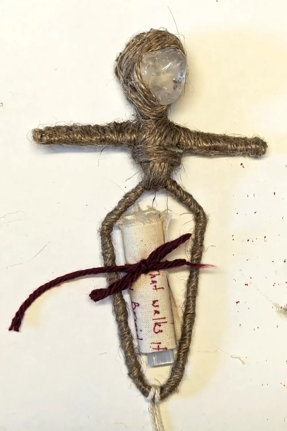 Brigit’s base form in progress, with a handwritten blessing wrapped around selenite and tied with red bow.