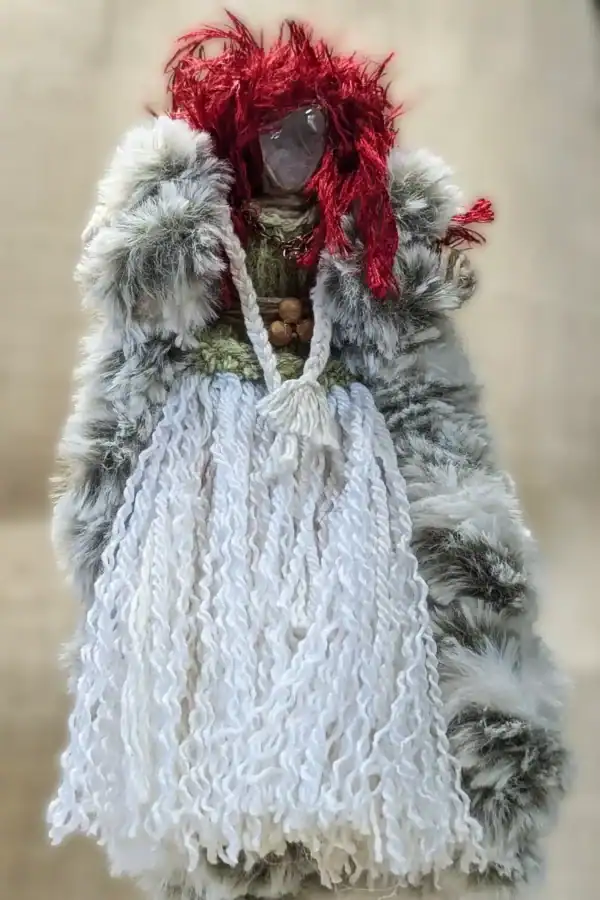 Full view of Brigit You-Do-You Voodoo™ doll with red yarn hair, clear quartz head, faux fur coat, wooden bead belt, and hand-tweaked white yarn skirt.