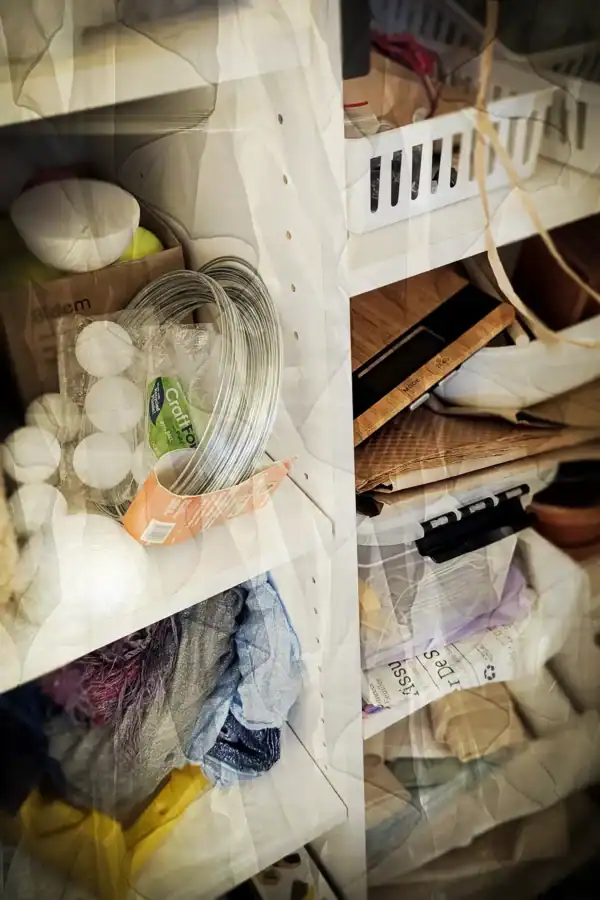 Shelves with wire, fabric, and artistic materials in Kellie Jo Art’s studio.