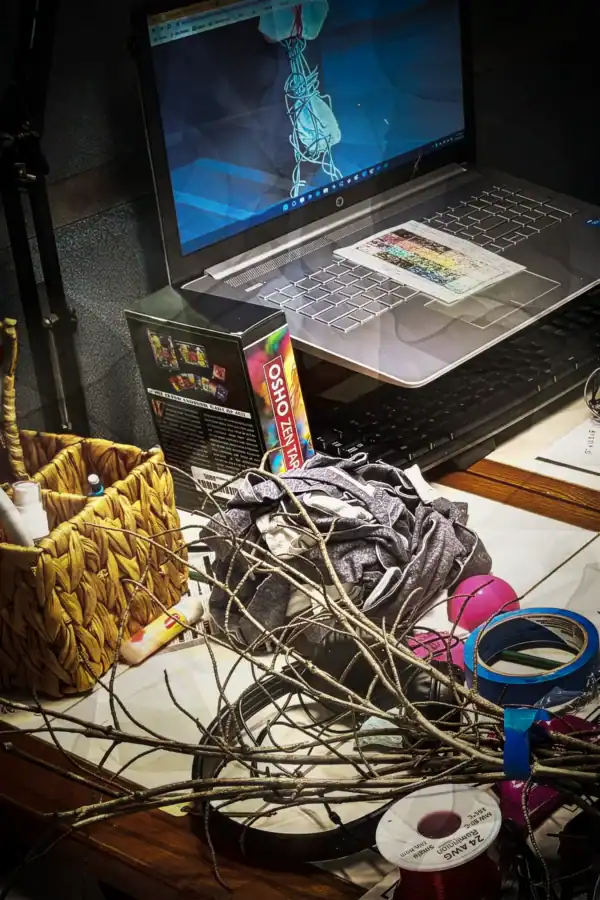 Artist workspace with materials and tools for commissioned artwork.