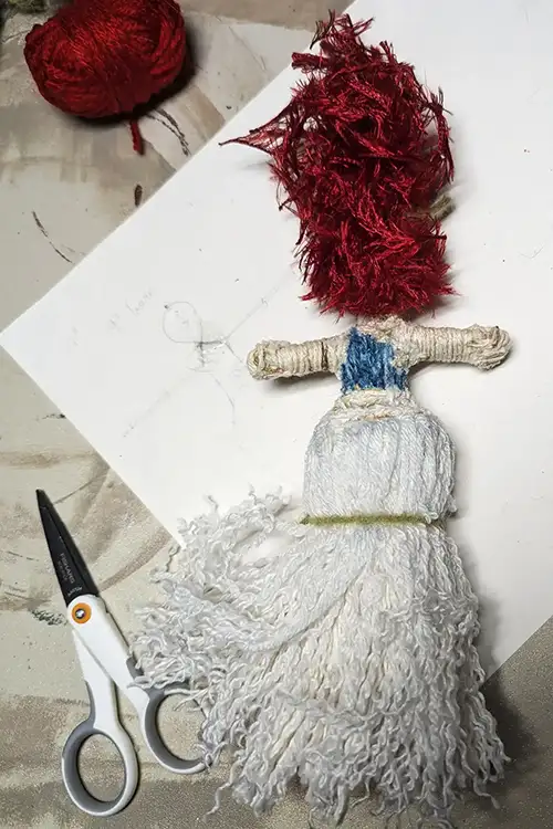 A You-Do-You Voodooâ„¢ doll on her creation sheet. The sheet is the record: every stone, herb, and color, and the reason each one is there.