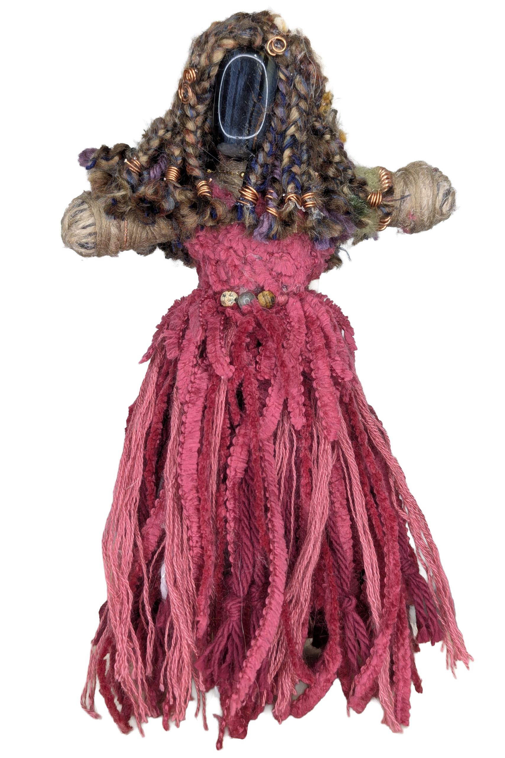 Handmade art doll with braided yarn hair, a stone face, copper wire coils, beaded belt, and a fringed pink yarn dress
